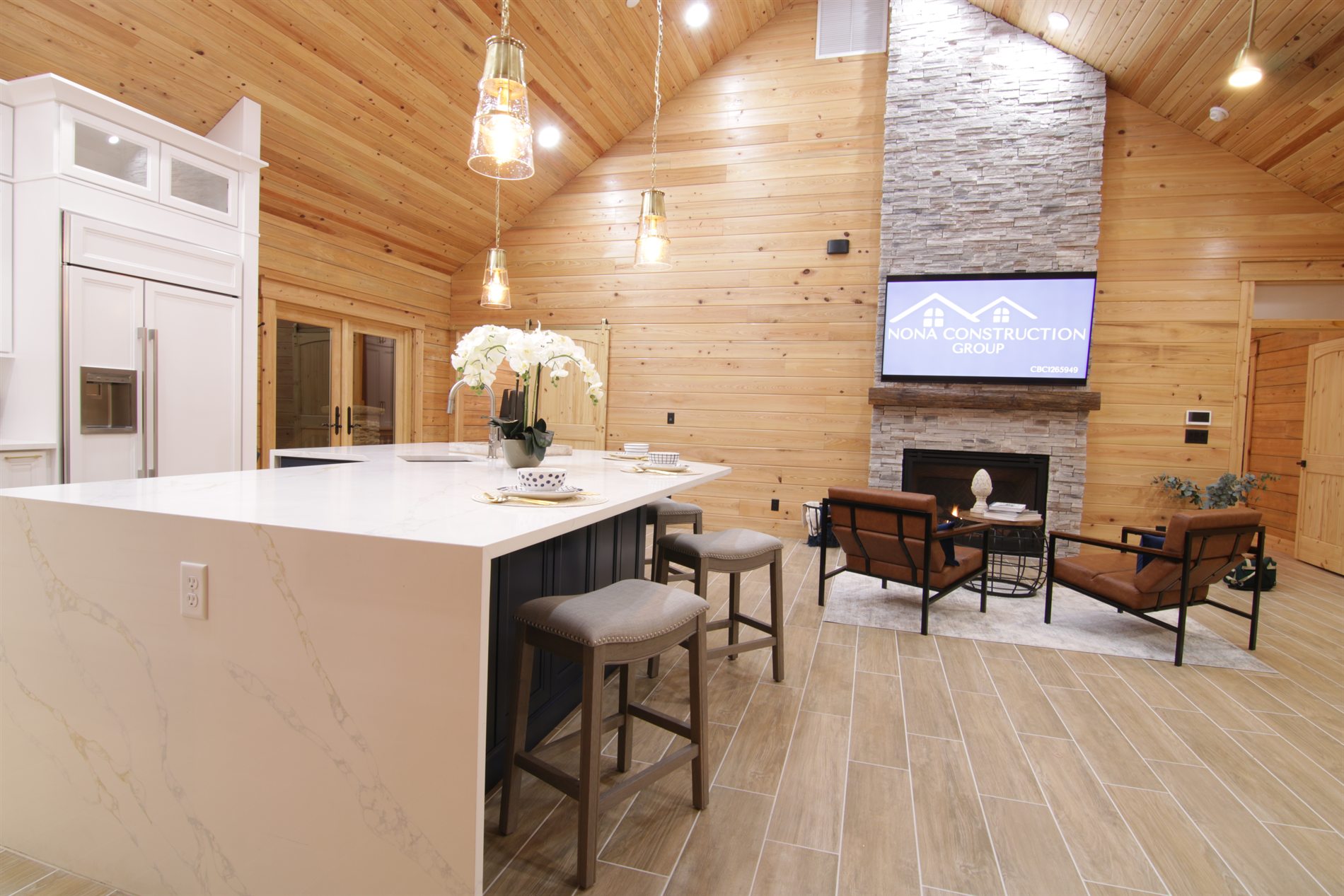 Open kitchen and stone fireplace great room inside a custom log cabin in Apopka Florida
