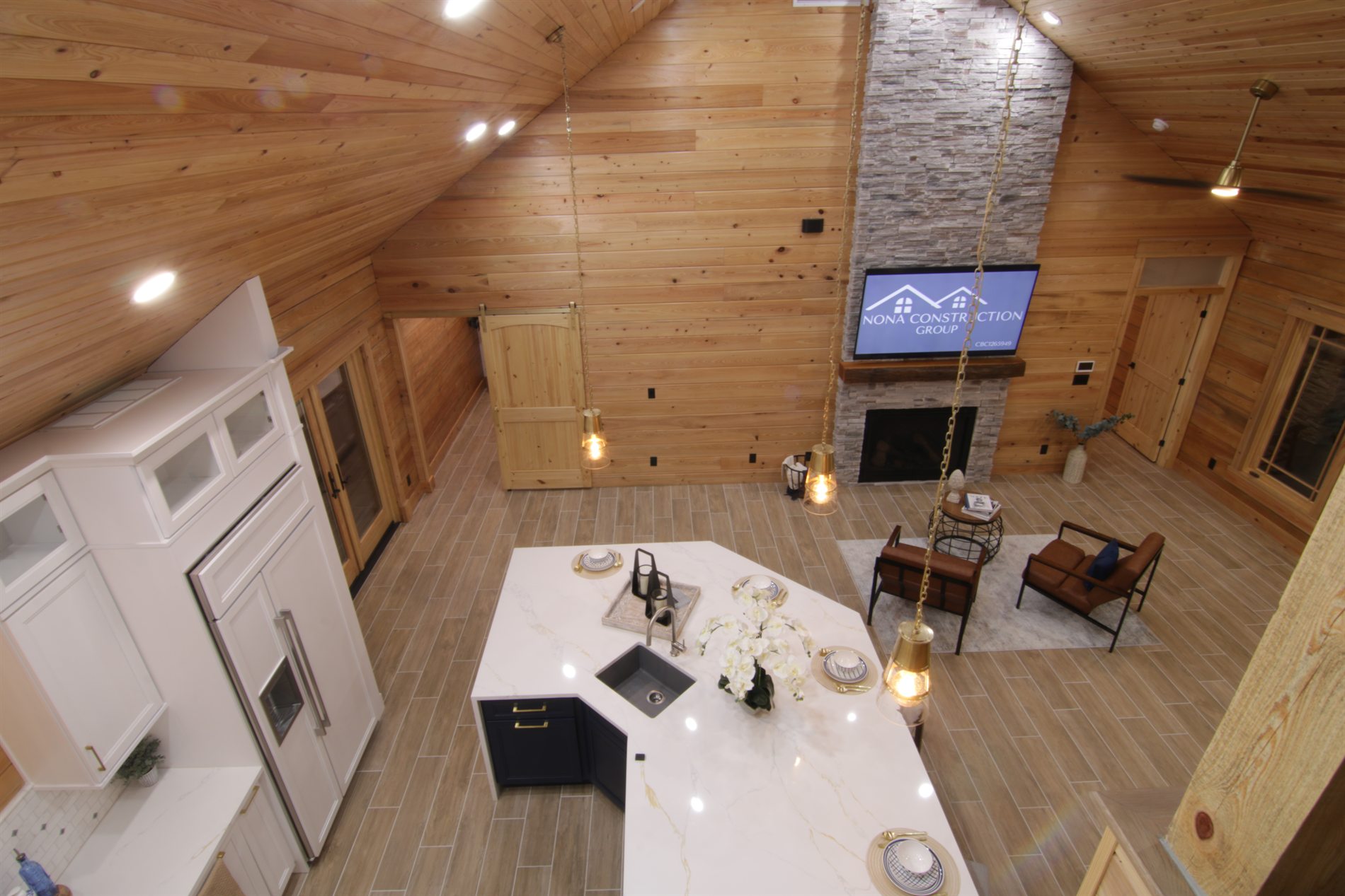 Loft overlook view of a custom log cabin great room with vaulted wood ceiling in Apopka