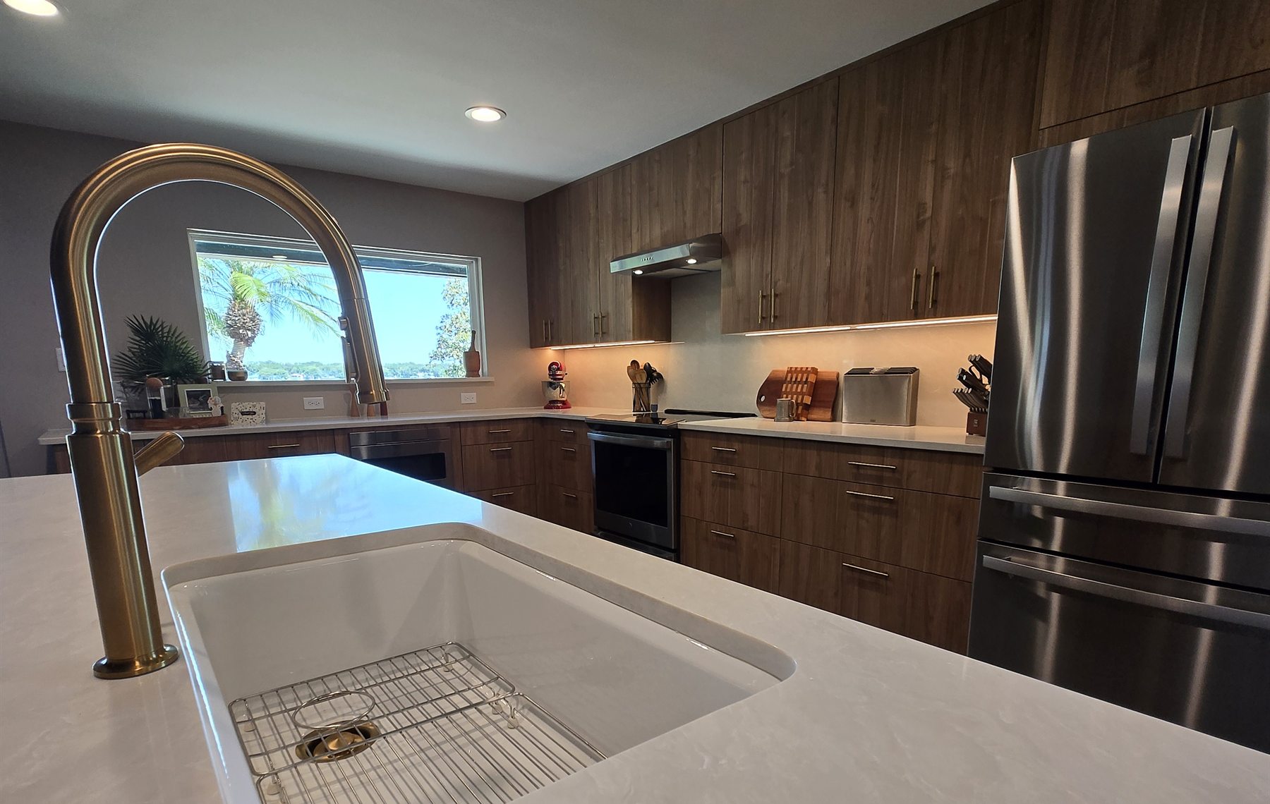 Quartz kitchen island and brass faucet in a Downtown Orlando kitchen remodel