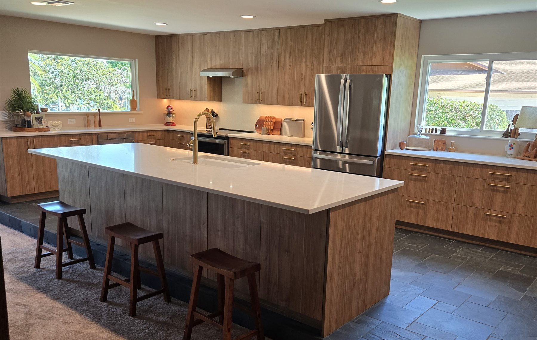 Downtown Orlando kitchen remodel with custom wood cabinetry, island, and stone flooring