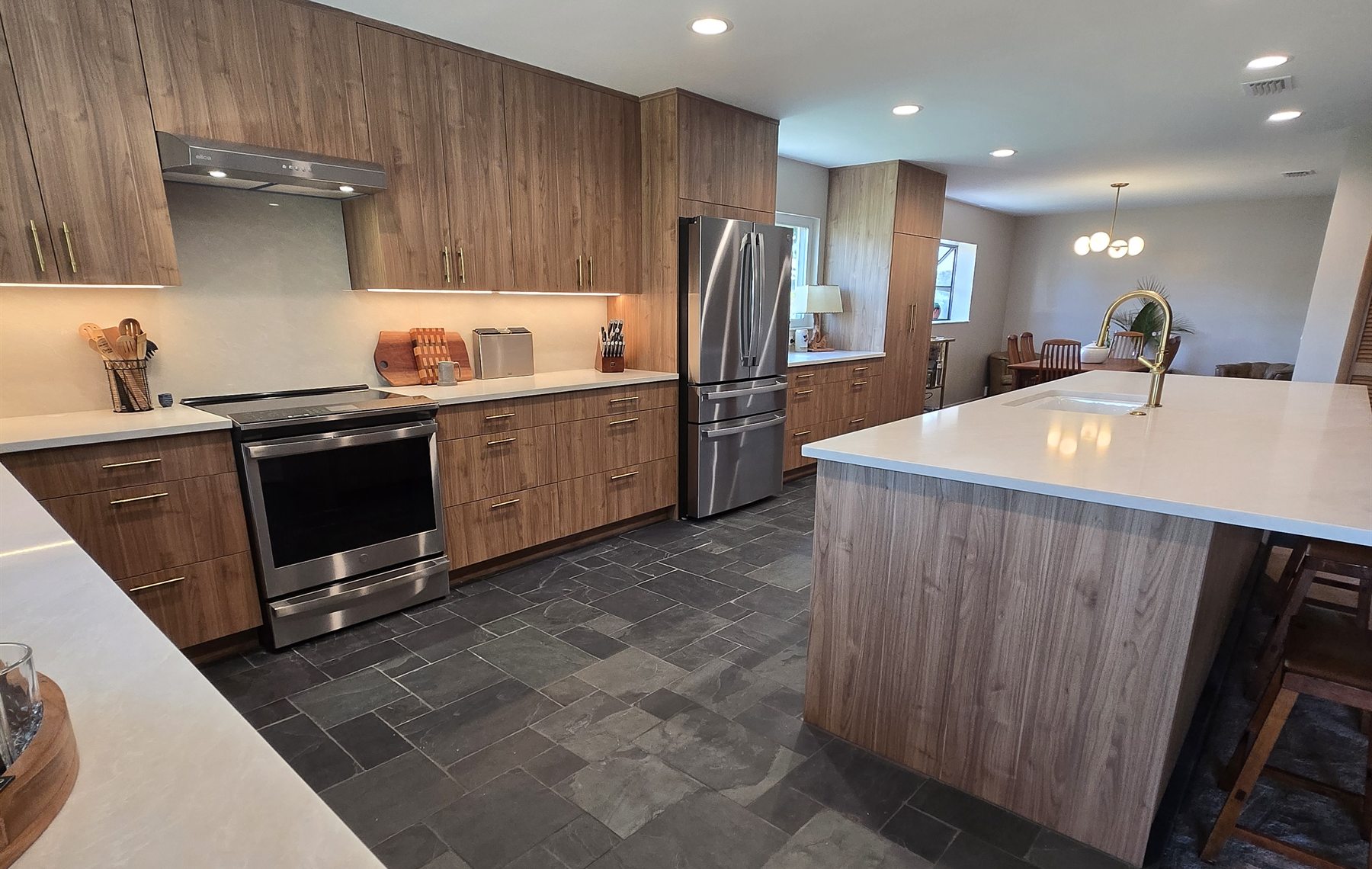 Large finished kitchen renovation with island, wood cabinetry, and stone flooring in Orlando