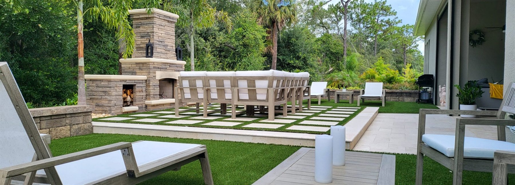 Outdoor living fireplace, turf, and tile installation in Orlando