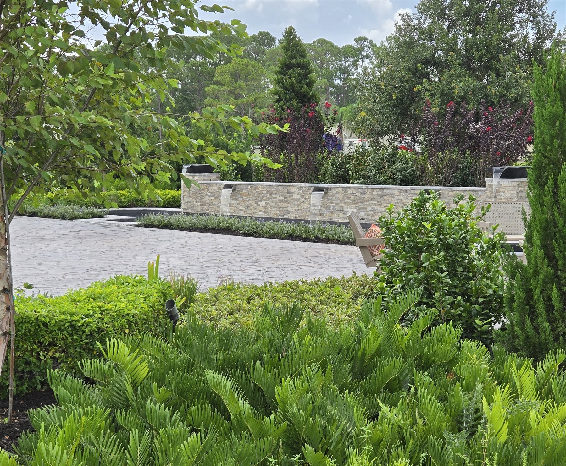 Outdoor living and pool landscape coordinated with a custom home project